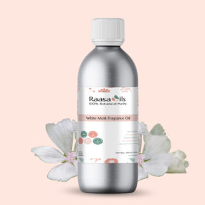 Bottle of Raasa Oils White Musk Fragrance Oil with white flowers on a light pink background