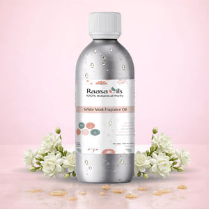 Bottle of Raasa Oils White Musk Fragrance Oil with flowers on a pink background