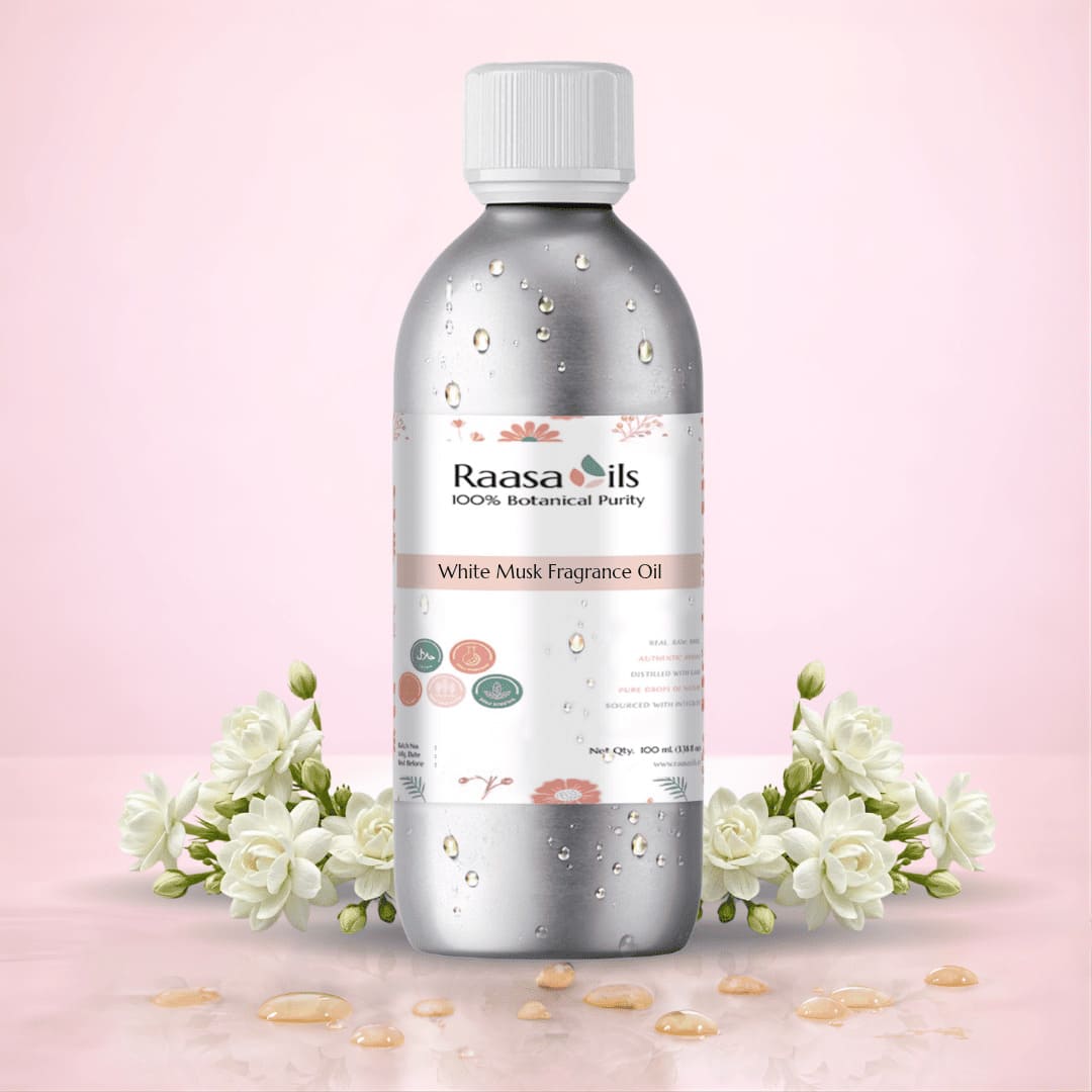 Bottle of Raasa Oils White Musk Fragrance Oil with flowers on a pink background