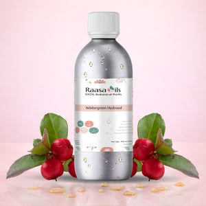 Bottle of Raasa Oils with watermelon leaves and seeds on a pink background