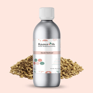 Bottle of Raasa Oils Alwain Hydrosol with fennel seeds on a pink background