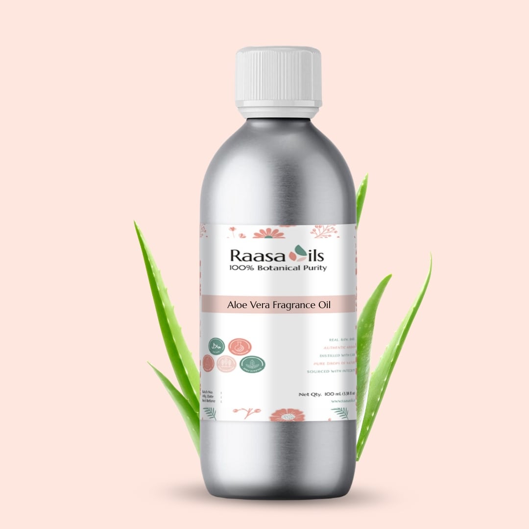 Bottle of Raasa Oils Aloe Vera Fragrance Oil with green leaves on a light pink background