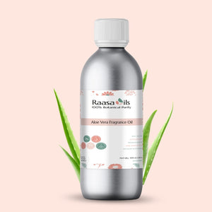 Bottle of Raasa Oils Aloe Vera Fragrance Oil with green leaves on a light pink background