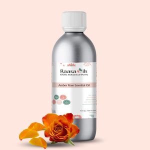 Bottle of Raasa Oils Amber Rose Essential Oil with an orange rose on a beige background