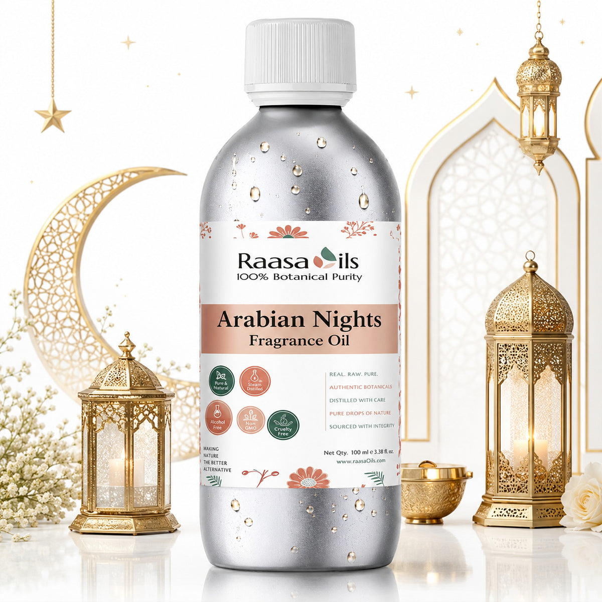 A bottle of Raasa Ils Arabian Nights Fragrance Oil, 100% botanical purity, in a metallic silver bottle with a white cap. The bottle is decorated with water droplets and features a white label with pink and green accents.