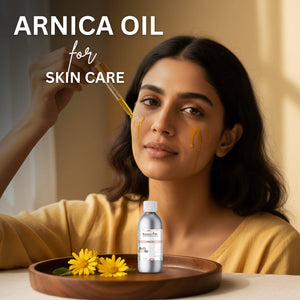 Woman applying Arnica oil to her face with a dropper, bottle, and flowers on a wooden tray.