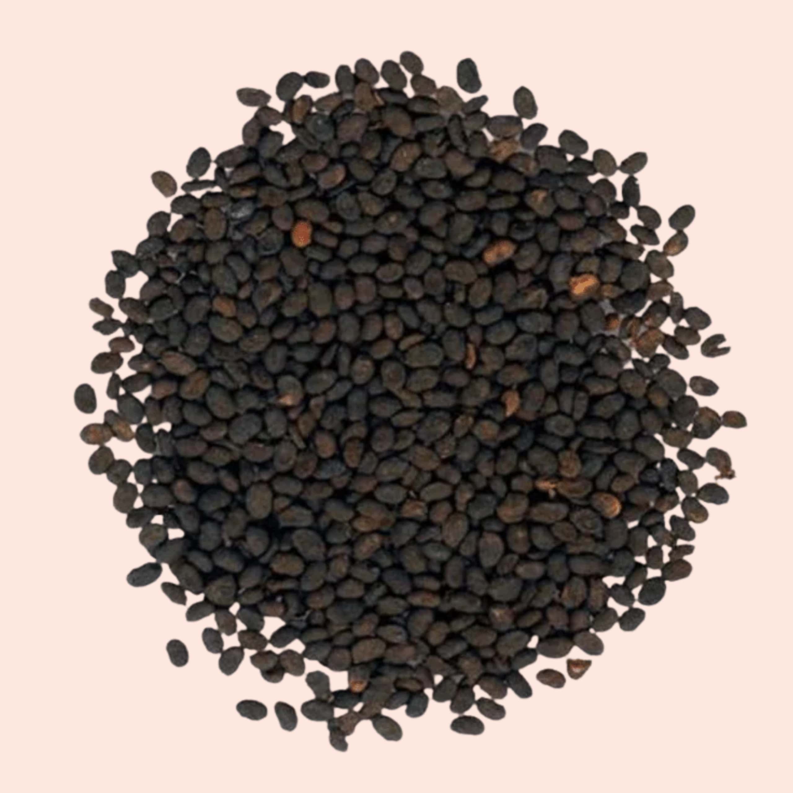 Close-up of black seeds on a beige background