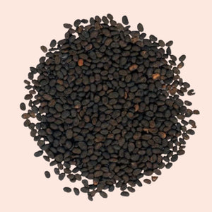 Close-up of black seeds on a beige background