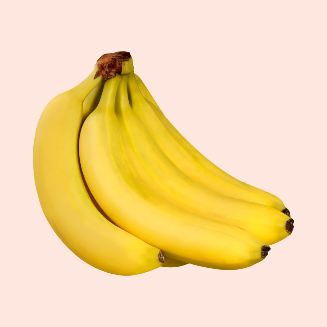 Bunch of yellow bananas on a light pink background