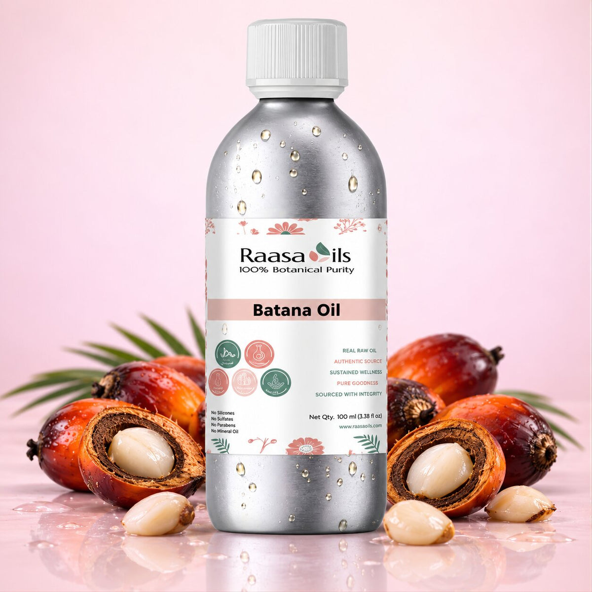 A bottle of Raasa Oils Batana Oil centered against a soft pink background, surrounded by whole and halved brown cashew fruits and a few pale cashew nuts on a reflective surface.