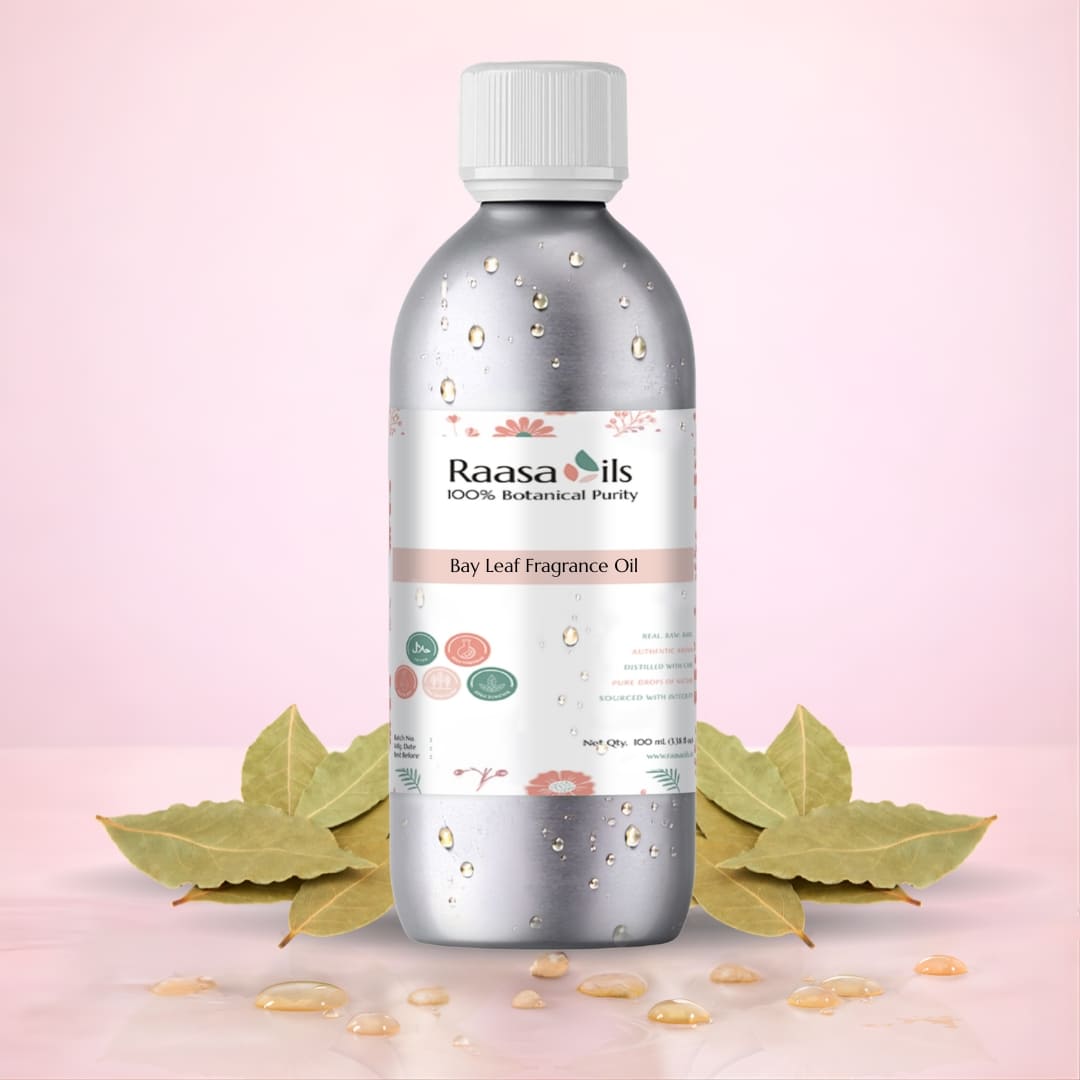 Raasa Oils Bay Leaf Fragrance Oil bottle with leaves on a pink background