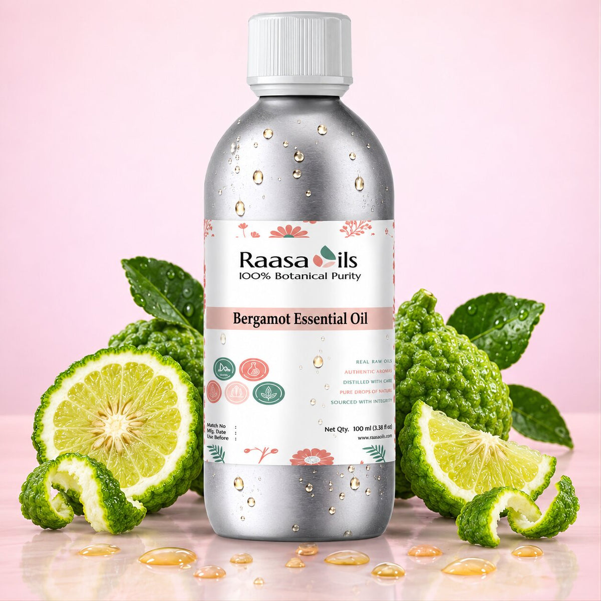 A bottle of Raasa Oils Bergamot Essential Oil centered on a pink background, surrounded by bergamot slices, bergamot fruit, and green leaves. The bottle is metallic silver with a white cap and a white label featuring pink and green botanical illustrations.