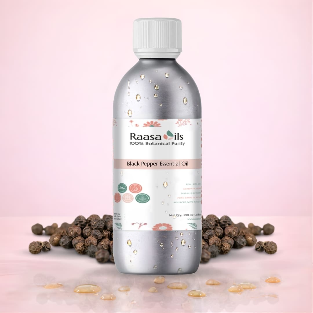 Raasa Oils black pepper essential oil bottle with peppercorns on a pink background