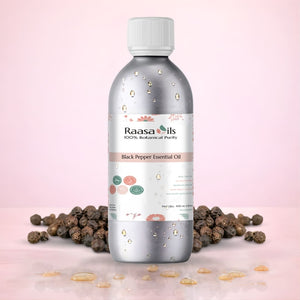 Raasa Oils black pepper essential oil bottle with peppercorns on a pink background