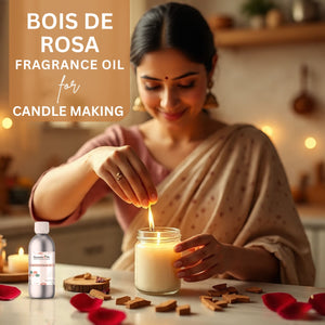 Woman lighting a candle with Bois de Rosa fragrance oil for candle making, surrounded by rose petals.