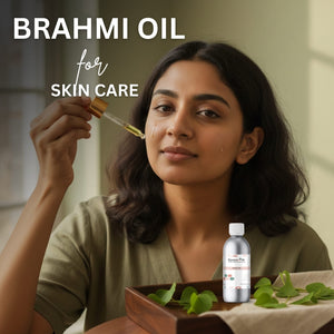 Woman holding Brahmi oil dropper with bottle and leaves on a table