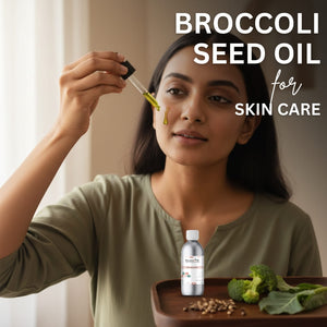 Woman applying broccoli seed oil to her face with a dropper, surrounded by broccoli and seeds on a wooden tray.