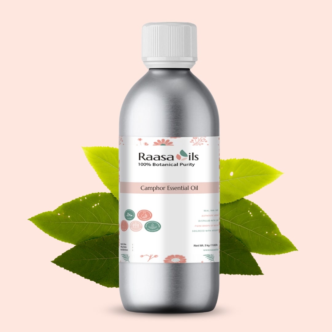 Raasa Oils Camphor Essential Oil bottle with green leaves on a light pink background