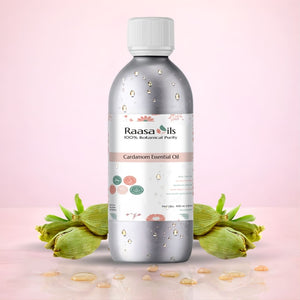 Raasa Oils Cardamom Essential Oil bottle with cardamom pods on a pink background