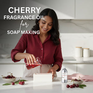 Woman pouring cherry fragrance oil into soap bars with cherry-themed decor in the background.