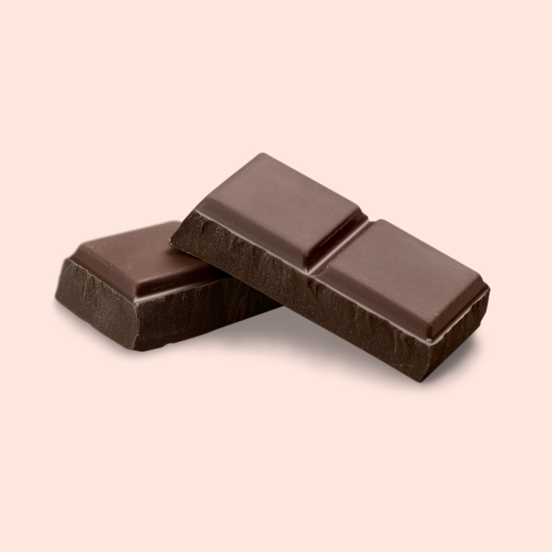 Two dark chocolate bars on a beige background