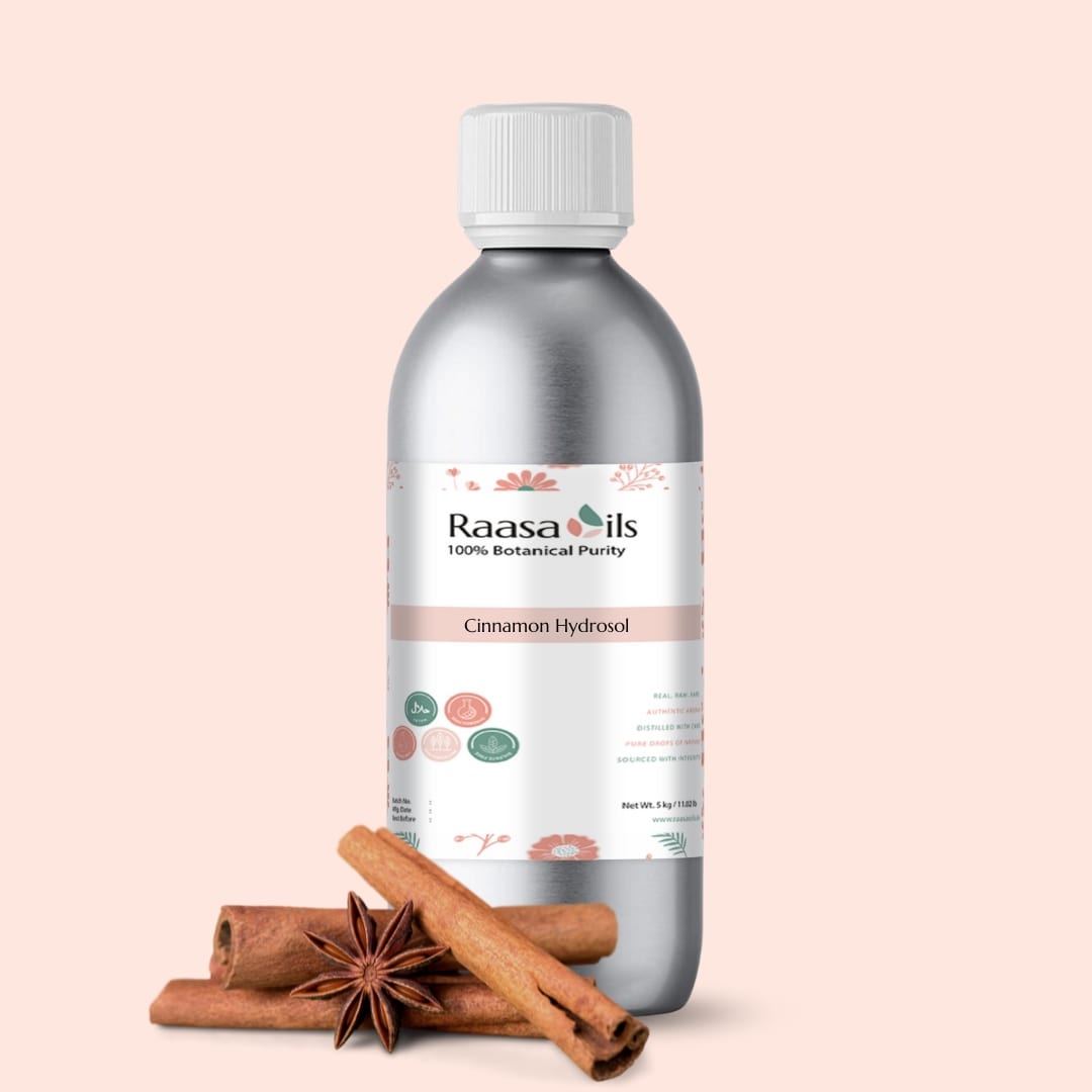 Raasa Oils cinnamon hydrosol bottle with cinnamon sticks and star anise on a beige background