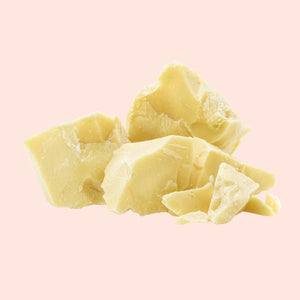Chunks of yellowish-white material on a pink background