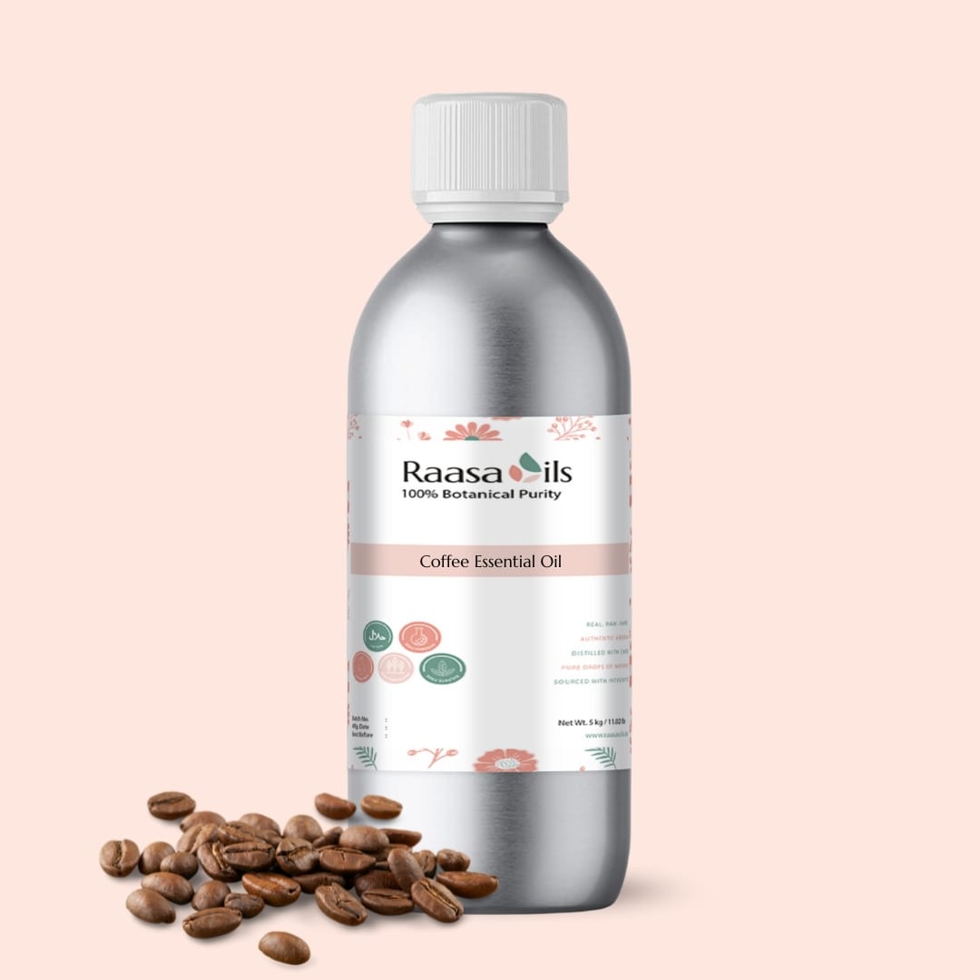 Bottle of Raasa Oils Coffee Essential Oil with coffee beans on a beige background