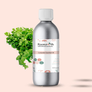 Bottle of Raasa Oils Coriander Essential Oil with coriander leaves on a beige background