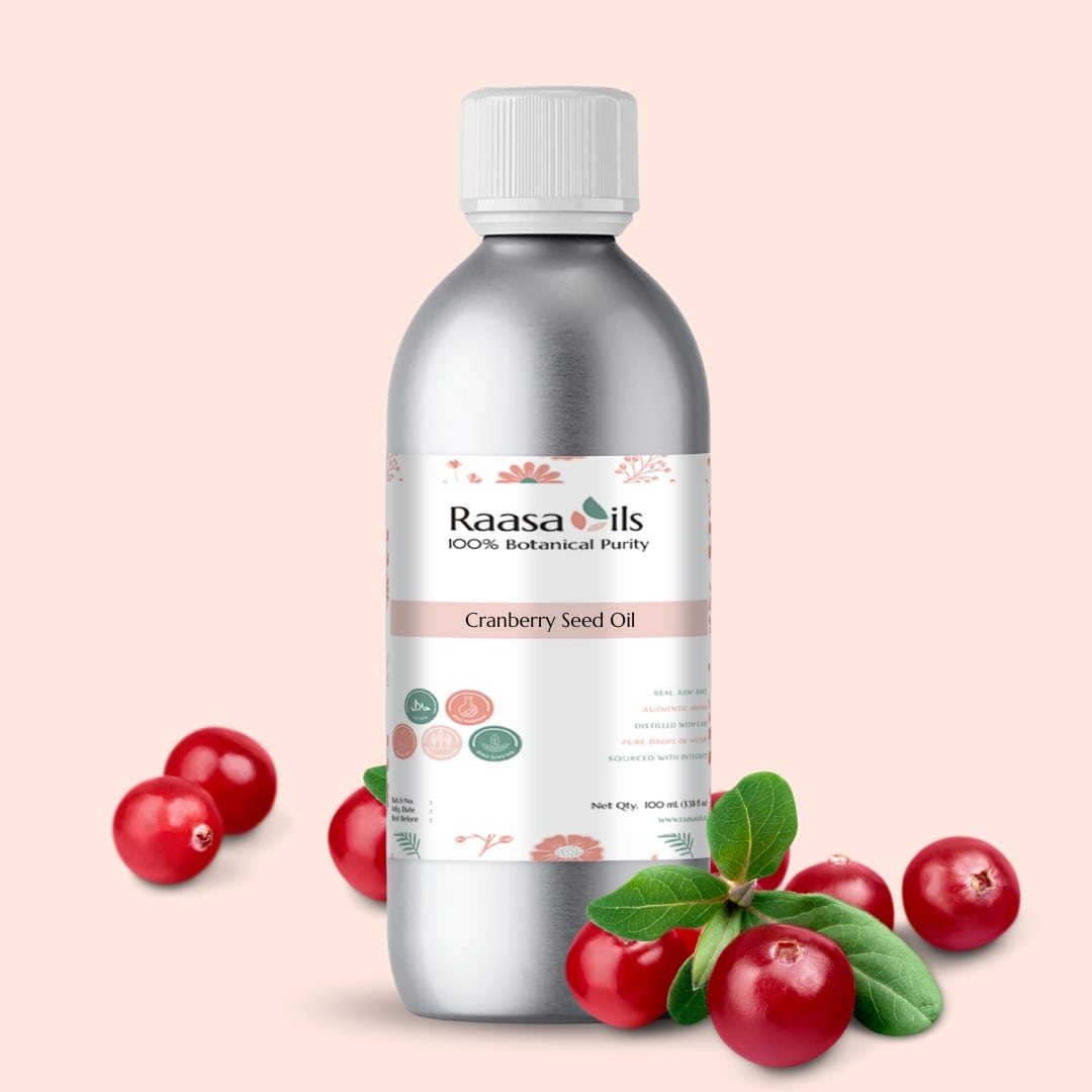 Bottle of Raasa Oils Cranberry Seed Oil with cranberries on a light pink background