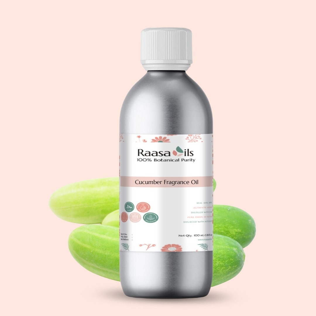 Bottle of Raasa Oils cucumber fragrance oil with cucumbers in the background on a light pink background