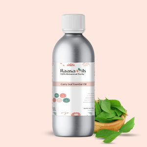 Bottle of Raasa Oils Curry Leaf Essential Oil with curry leaves on a beige background