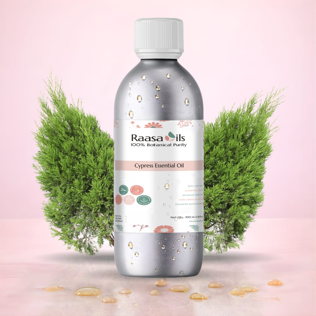 Raasa Oils Cypress Essential Oil bottle with green plants on a pink background