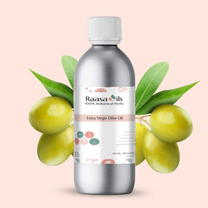 Bottle of Raasa Oils Extra Virgin Olive Oil with olives and leaves on a light pink background