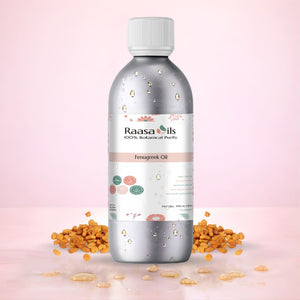 Bottle of Raasa Oils Fenugreek Oil with fenugreek seeds on a pink background