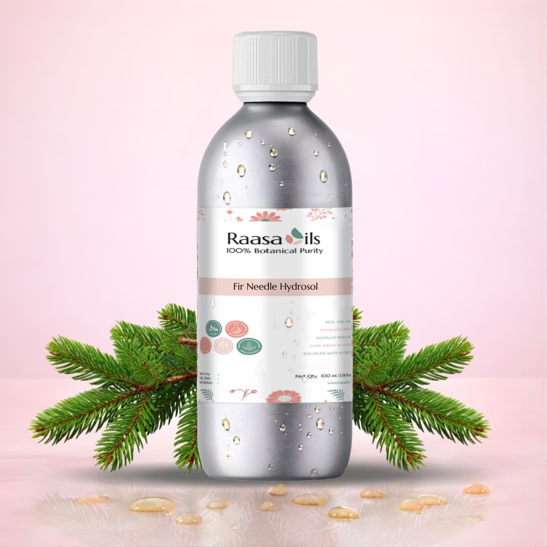 Fir Needle Hydrosol Bottle of Raasa Oils with a pink background and green leaves