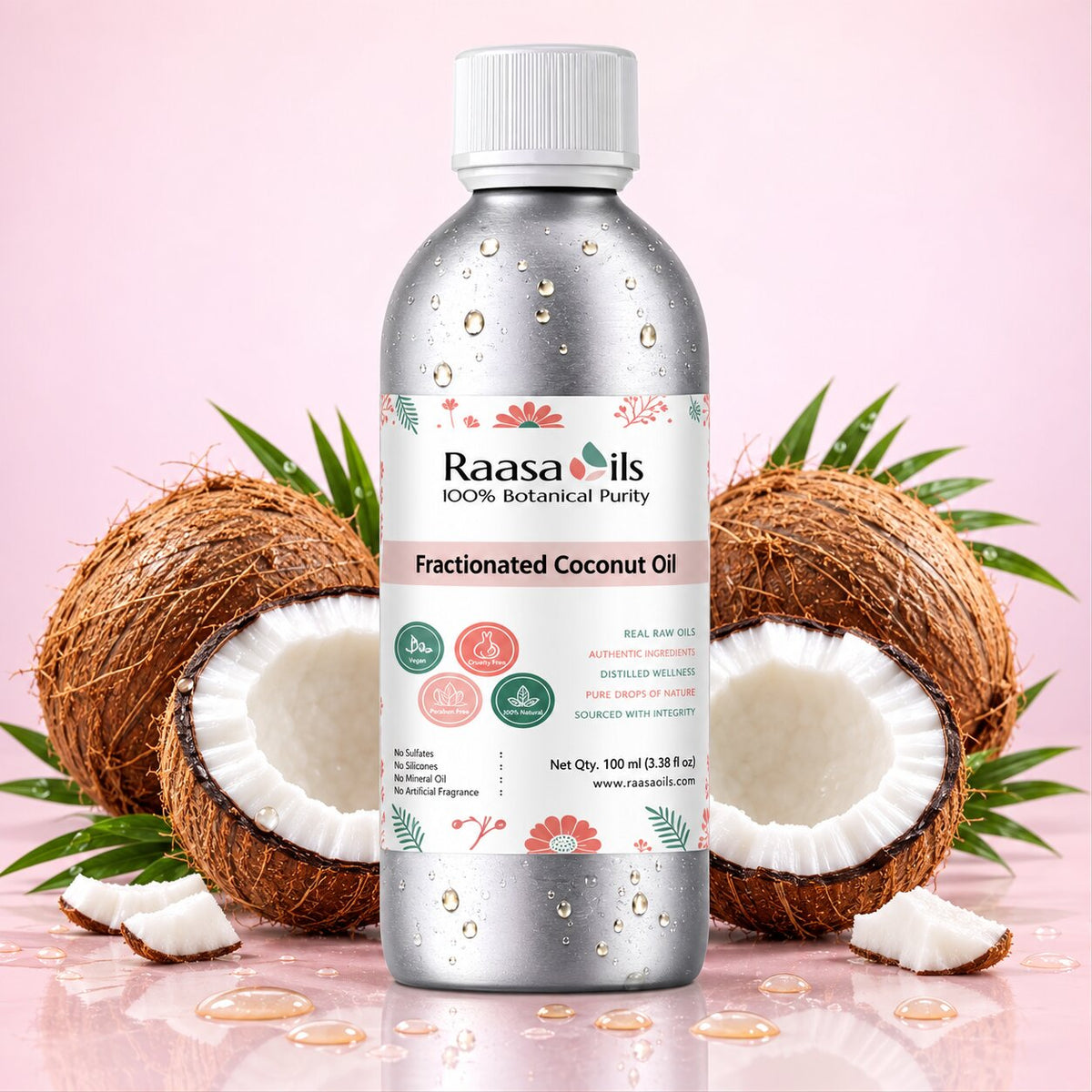 Bottle of Raasa Oils Fractionated Coconut Oil with coconuts on a pink background