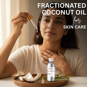 Woman applying fractionated coconut oil to her skin with a dropper, surrounded by coconut pieces and a bottle of the oil.