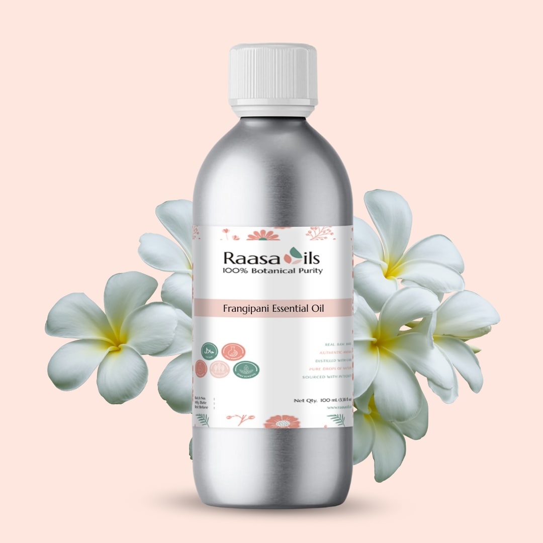 Raasa Oils Frangipani Essential Oil bottle with flowers on a light pink background