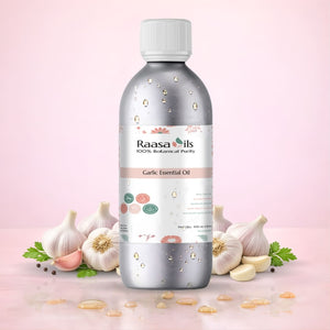 Bottle of Raasa Oils Garlic Essential Oil with garlic bulbs and ingredients on a pink background