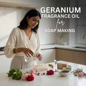 Woman in a kitchen preparing soap with geranium fragrance oil, surrounded by flowers and soap-making ingredients.