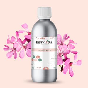 Silver bottle of Raasa Oils Geranium Hydrosol with pink flowers on a light pink background