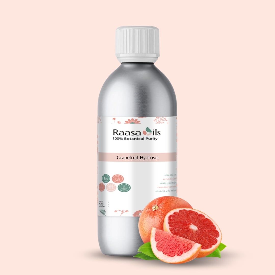 Raasa Oils Grapefruit Hydrosol bottle with grapefruit slices on a light pink background