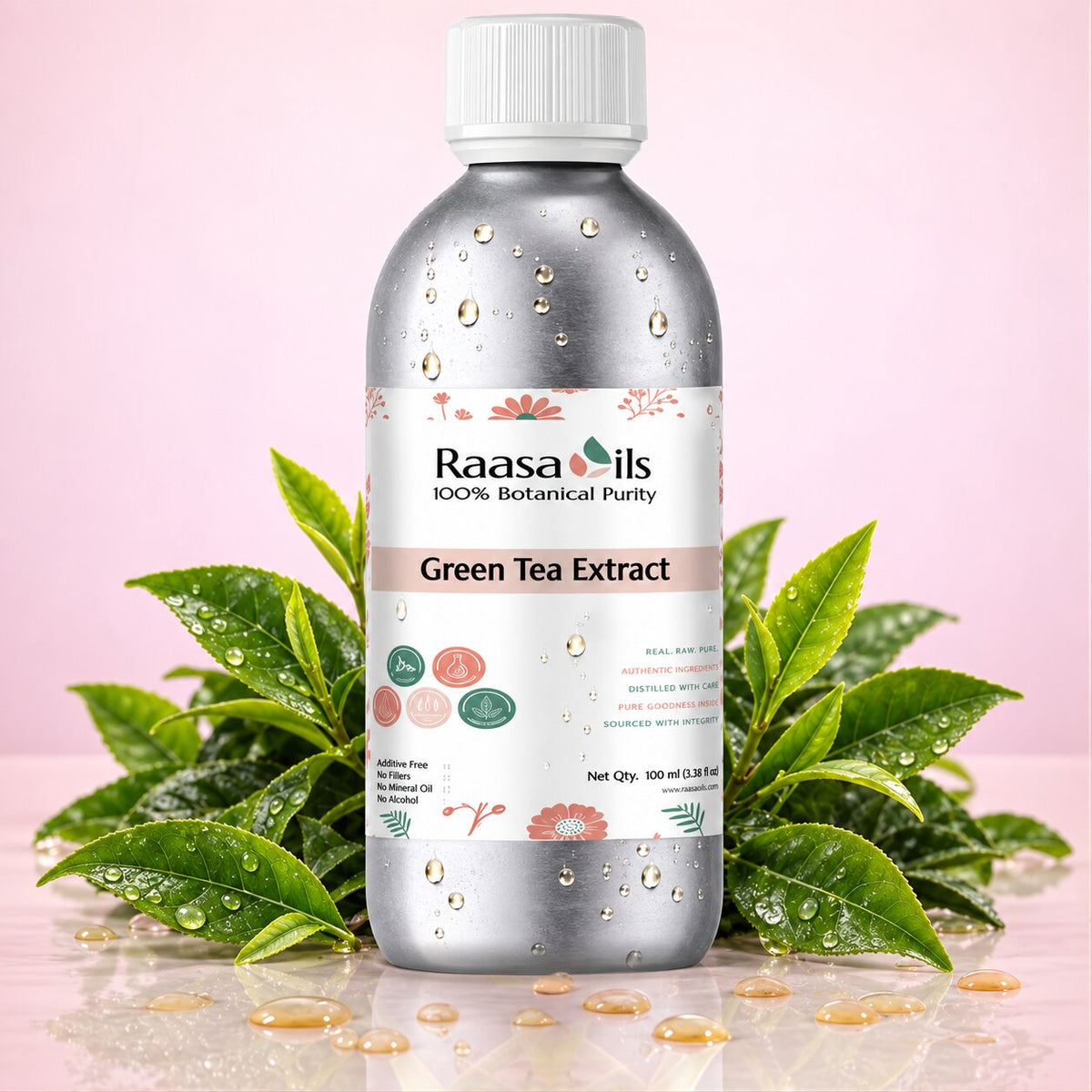 A bottle of Raasails Green Tea Extract centered on a reflective surface with green tea leaves and water droplets around it, against a soft pink background.