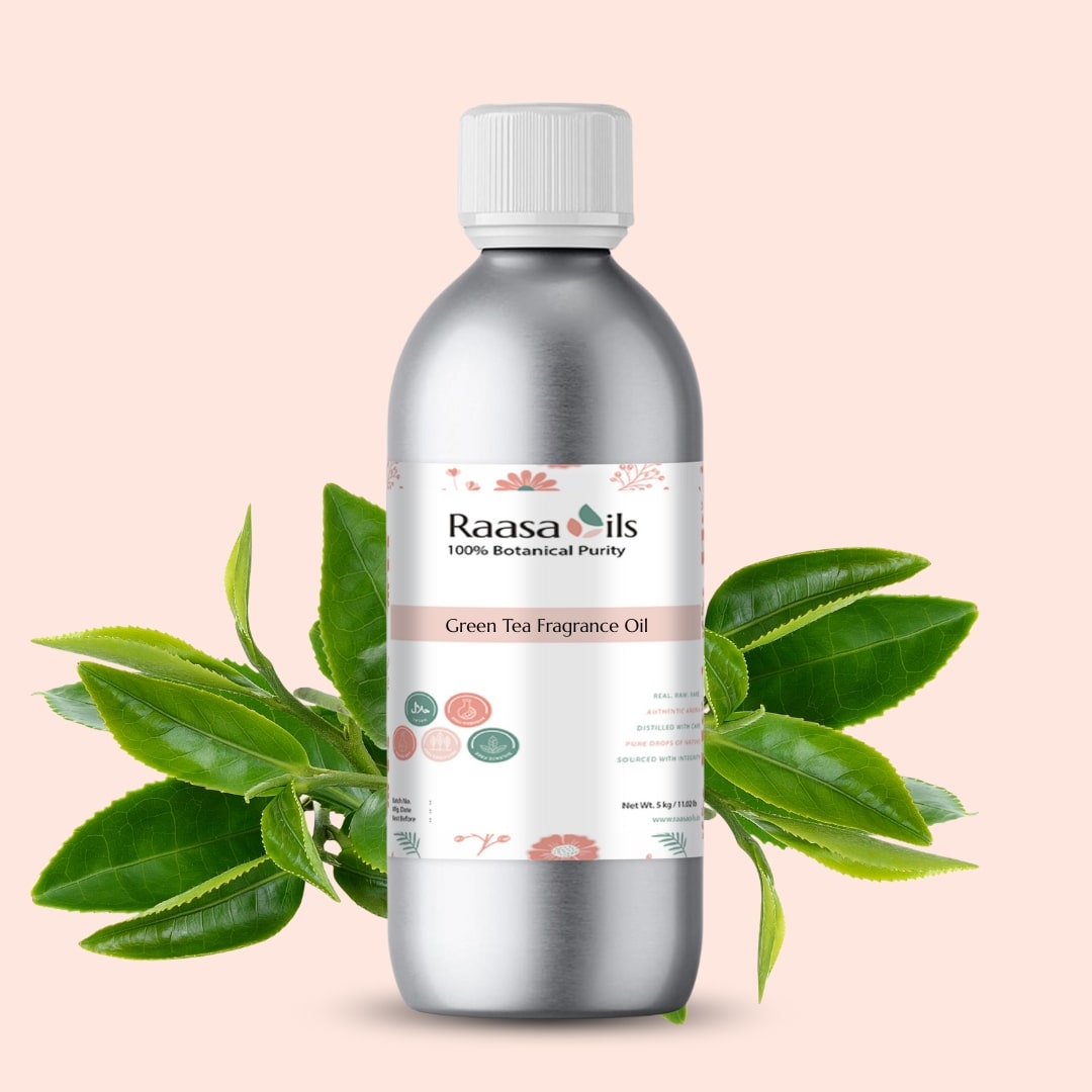 Bottle of Raasa Oils Green Tea Fragrance Oil with green leaves on a beige background