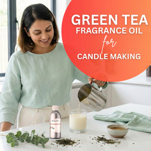 Woman pouring liquid into a glass with green tea fragrance oil for candle making, surrounded by tea leaves and a bottle of the product.