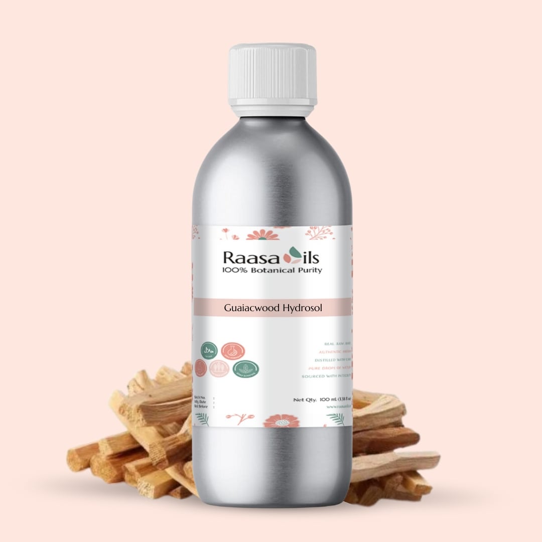 Bottle of Raasa Oils Guggalwood Hydrosol with wooden sticks on a beige background