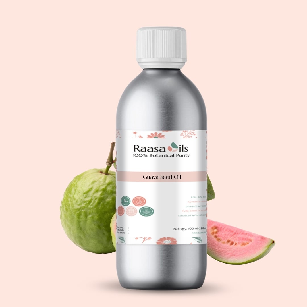 Bottle of Raasa Oils Guava Seed Oil with guava fruit on a pink background