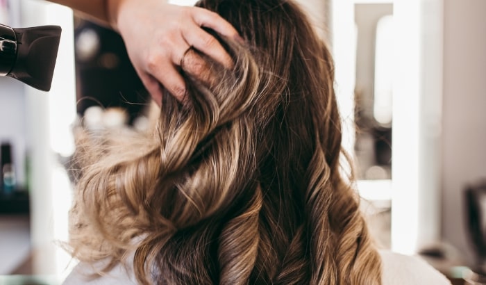 Person with styled hair in a salon setting