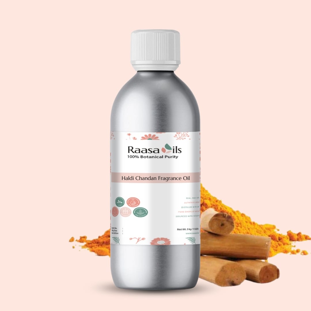 Bottle of Raasa Oils Haldi Chandan Fragrance Oil with turmeric and wooden sticks on a beige background